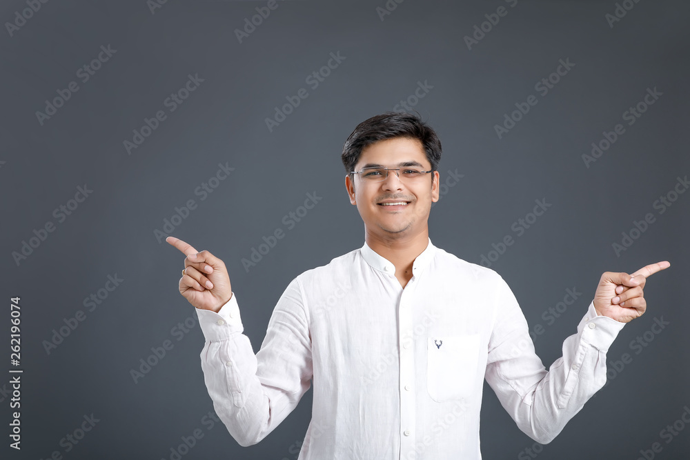 Indian young man showing direction with hand Indian young man showing direction with hand