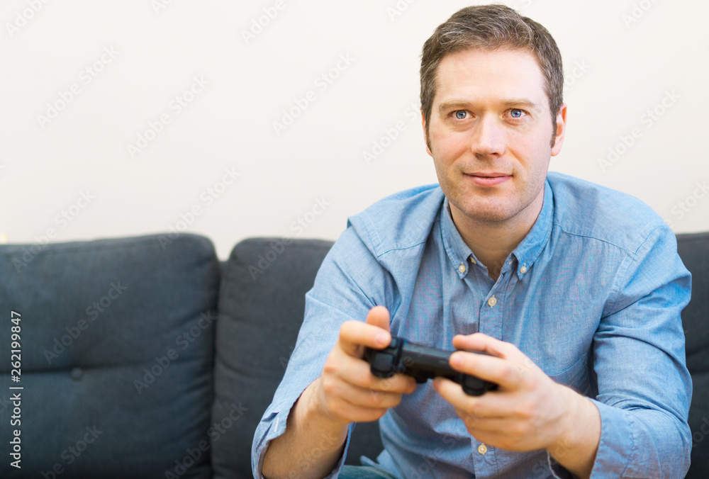 Man playing video game with gamepad in hands. Man playing video game with gamepad in hands.