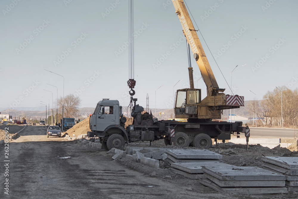 Mobile crane truck KAMAZ at the at the construction site. Mobile crane truck KAMAZ at the at the construction site.