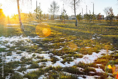 Spring, Snow melting on green grass
