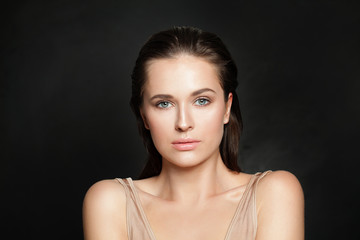 Sensual woman model with clear healthy skin on black background