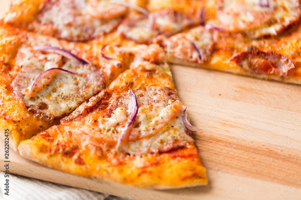 food, culinary and eating concept - close up of sliced homemade pizza on wooden table food, culinary and eating concept - close up of sliced homemade pizza on wooden table