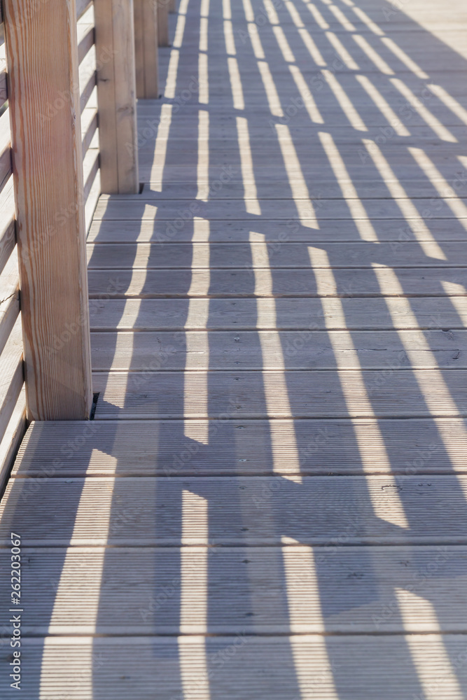 Railing Shadows on the wooden bridge for background.