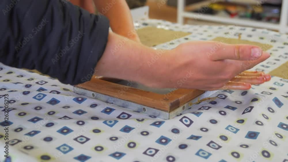 Learning how to make paper the traditional way, pressing down a deckle frame, during a workshop for crafters. Learning how to make paper the traditional way, pressing down a deckle frame, during a workshop for crafters.