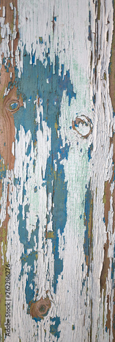 Old wooden board with cracks and the exfoliated paint