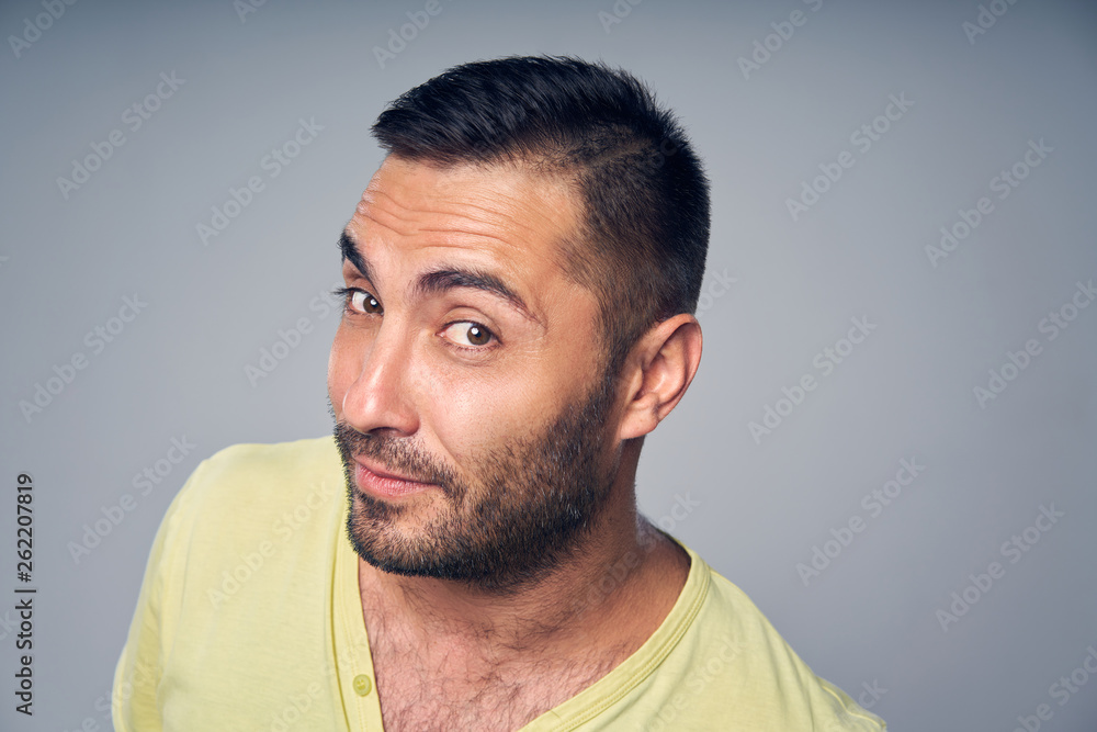 Fototapeta premium Closeup of hispanic man peeking in camera