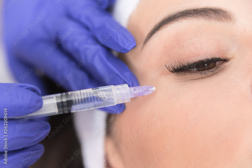 Doctor injecting substance with syringe Doctor injecting substance with syringe