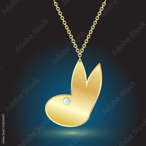 gold pendant jewelry on dark background with backlight.