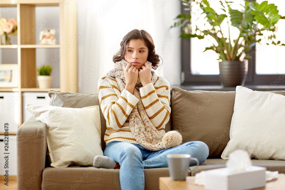 people, health and cold concept - sad sick woman in scarf at home people, health and cold concept - sad sick woman in scarf at home