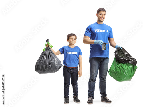 Young man and a child volunteers collecting waste in plastic bags