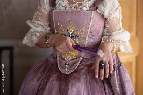 Retro style royal medieval ball - Majestic palace with gorgeous people dressed in king and queen's friends dresses with accessories such as fan and hand puch as a handbag - 2019