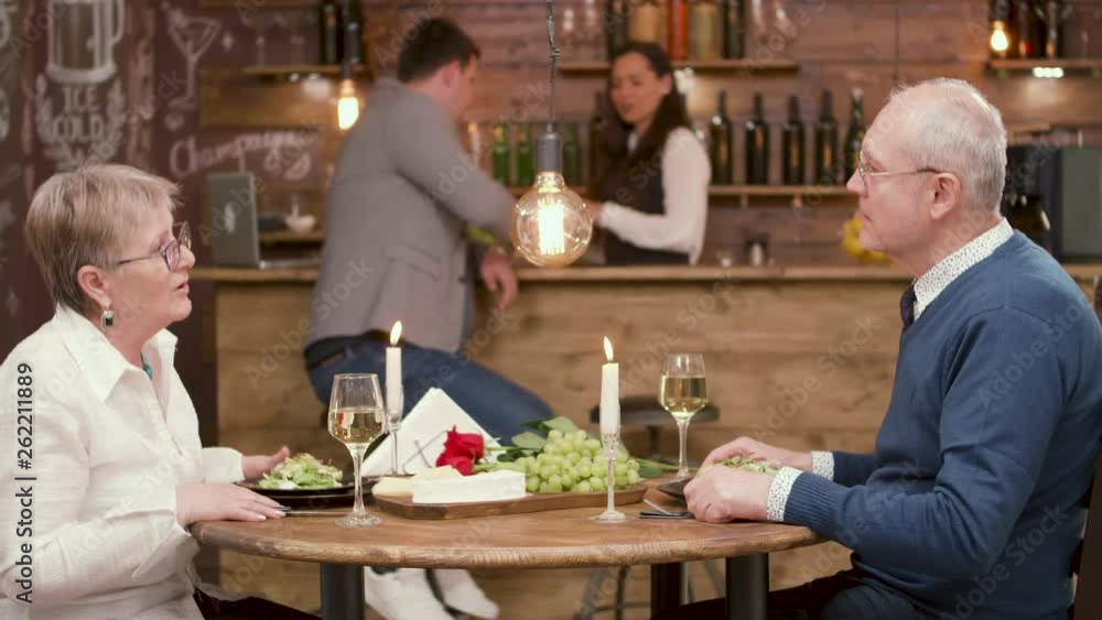 Older couple on a blind date in a restaurant. Old people have dinner in a pretty restaurant. Older couple on a blind date in a restaurant. Old people have dinner in a pretty restaurant.