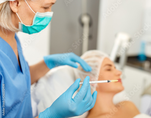 Female client receiving cosmetic injection from professional cosmetician