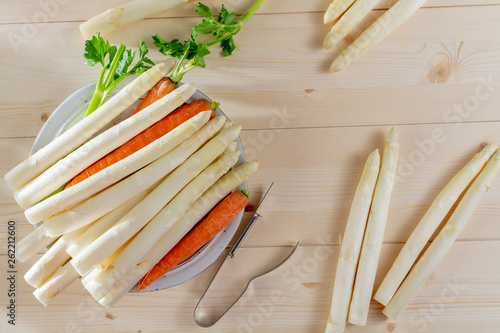 New harvest of white asparagus, high quality raw asparagus, carrot and selery in spring season, ready to cook photo