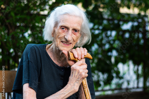 Portrait of a senior woman with a walking cane photo