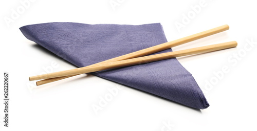 Paper napkins with chopsticks isolated on white background