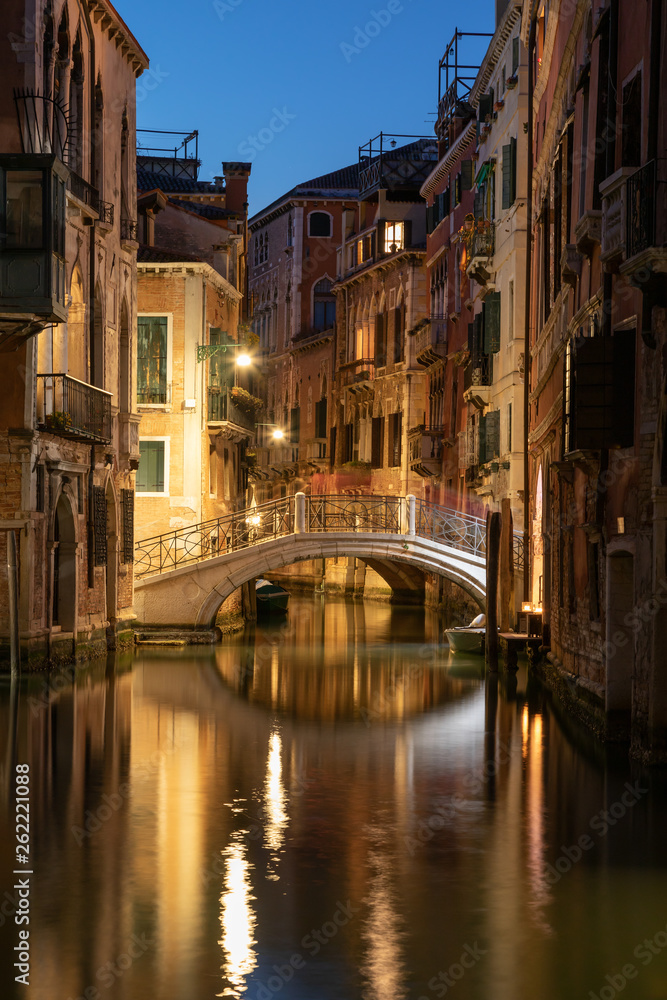 View into a small canal in Venice by night
