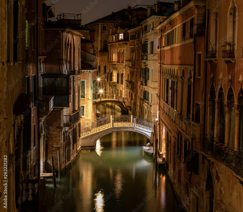 View into a small canal in Venice by night
