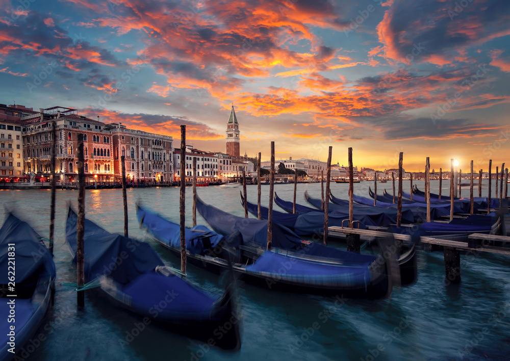 The famous Gondolas are parking on a Canal Grande at the sunset in Venice Italy