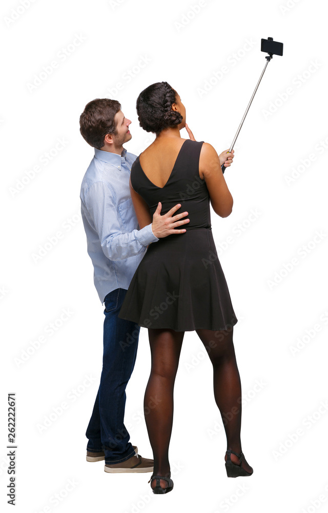 Back view of an interracial couple that makes selfie on selfie s Back view of an interracial couple that makes selfie on selfie s