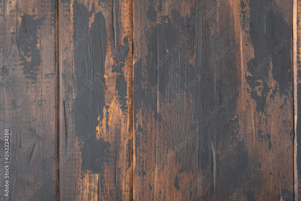 Old wooden surface background, scuffed boards with black paint stains.