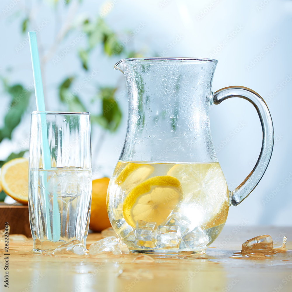 Infused water with cucumber, lemons and mint in a pitcher Infused water with cucumber, lemons and mint in a pitcher