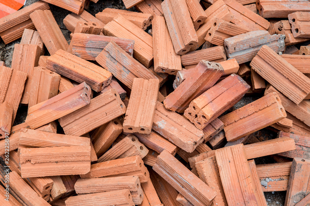 group of bricks square construction materials. bricks texture and abstract in vignette for background or copy space for text fill. Stack of disorganized brown bricks. group of bricks square construction materials. bricks texture and abstract in vignette for background or copy space for text fill. Stack of disorganized brown bricks.