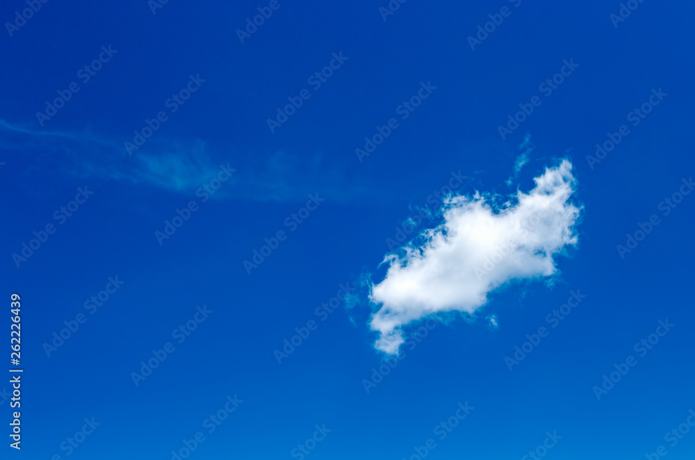 A solitary little cloud crosses the blue sky over the Andean mountains of central Colombia. A solitary little cloud crosses the blue sky over the Andean mountains of central Colombia.