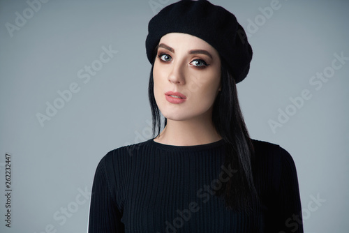 Closeup of a woman wearing beret hat looking at camera