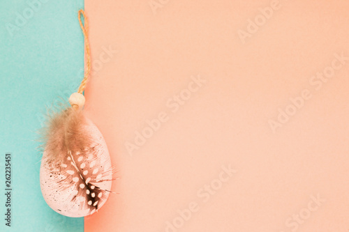 Pink pastel big Easter egg decorated with ribbon and bird feathe photo