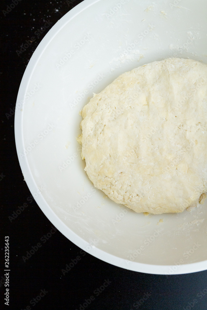 Raw mixed dough lies in a mixing bowl