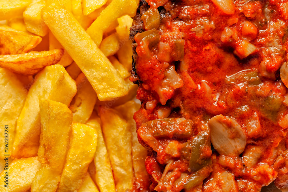 Meat in tomato sauce with french fries Meat in tomato sauce with french fries