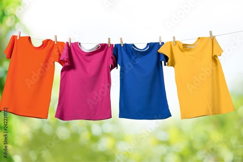 Wash clothes on a rope with clothespins on background