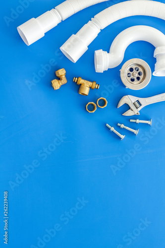 Professional instruments for plumber on blue background top view space for text