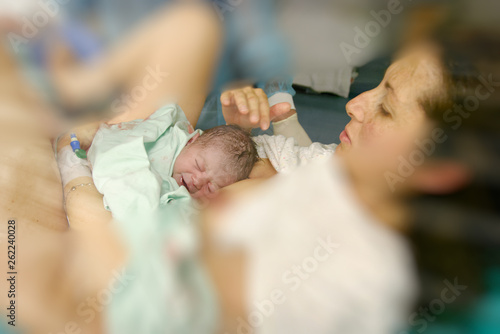 A mother with her newborn child in the hospital after giving birth to the baby