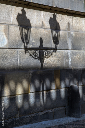 The reflection of the street lamp on the wall of the temple in Prague