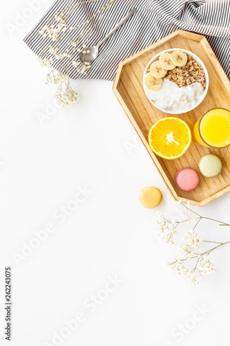 Bright breakfast with granola and orange juice on white background top view mockup