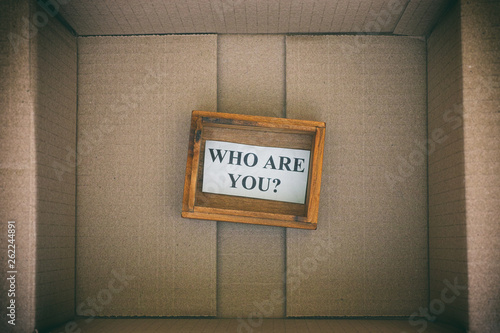 Fototapeta Naklejka Na Ścianę i Meble -  Wooden box with question Who are you inside cardboard box
