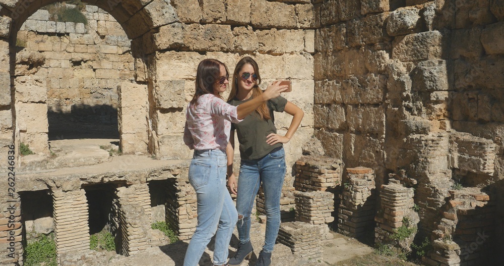 Tourists take photos near ancient temple roman architecture in open air museum Tourists take photos near ancient temple roman architecture in open air museum
