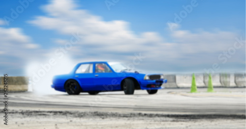 Abstract blurred old car drifting, Sport car wheel drifting and smoking on blurred background. Motorsport concept. © applezoomzoom