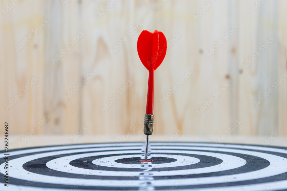 Winner Red dart arrow hit the center target of dartboard and yellow arrow loser metaphor marketing competition concept Winner Red dart arrow hit the center target of dartboard and yellow arrow loser metaphor marketing competition concept