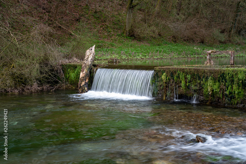 Waterfall cascades on the River Lathkill, Lathkill Dale, Peak District, Derbyshire.