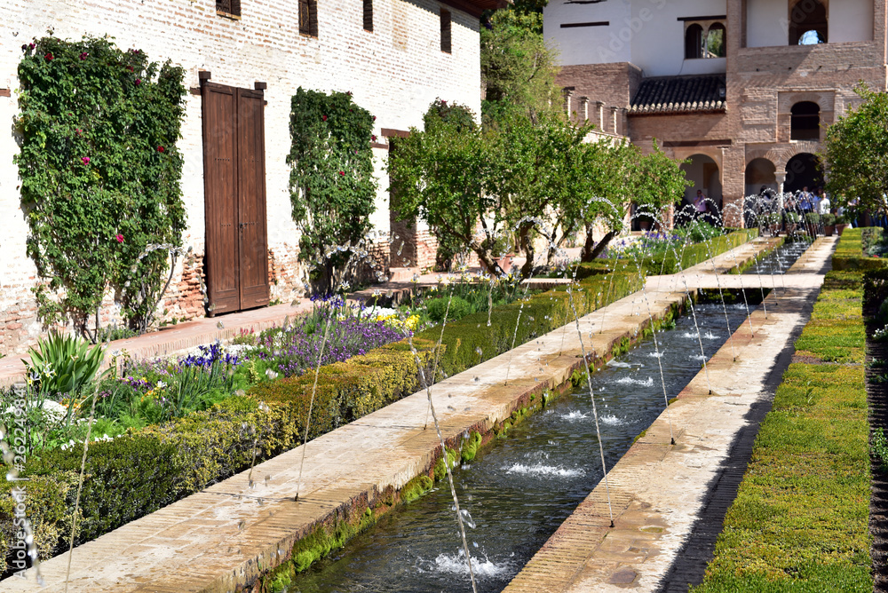 View of The Generalife courtyard, with its famous fountain and gardens, Alhambra complex at Granada, Spain