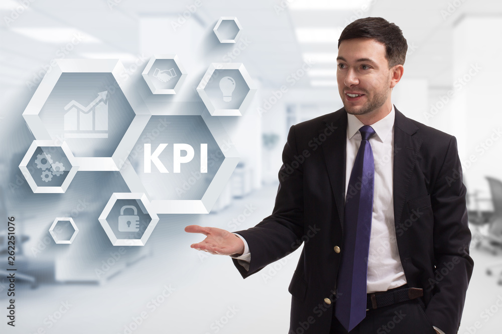 The concept of business, technology, the Internet and the network. A young entrepreneur working on a virtual screen of the future and sees the inscription: KPI The concept of business, technology, the Internet and the network. A young entrepreneur working on a virtual screen of the future and sees the inscription: KPI