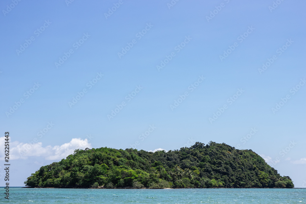 Mountain island over the sea with bright sky in background in the afternoon at Koh Mak Island in Trat, Thailand. Background with copy space. Mountain island over the sea with bright sky in background in the afternoon at Koh Mak Island in Trat, Thailand. Background with copy space.