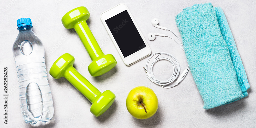 Dumbbells, measuring tape, water and apple top view. Dumbbells, measuring tape, water and apple top view.