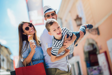 Happy family having fun outdoor after shopping