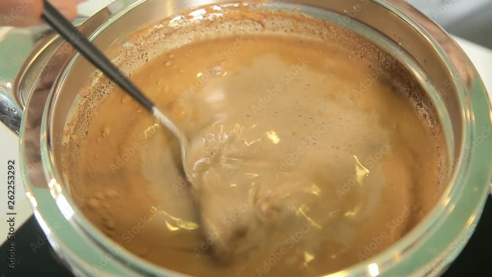 Melting chocolate with milk in a saucepan Melting chocolate with milk in a saucepan