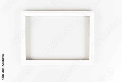 White decorative frame with ornament on white surface
