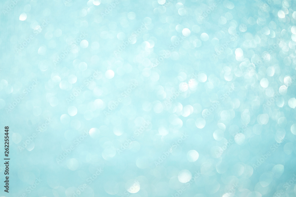 Blurred bokeh light blue background, Christmas and New Year holidays background. Party concept. Festive holiday card bright backdrop. Defocused. Flat lay, top view, copy space.